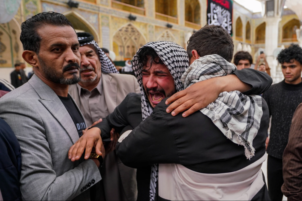 Relatives grieve an Iraqi soldier killed in a strike Wednesday on a military clinic in western Iraq’s Anbar province, during a mass procession inside the shrine of Imam Ali in Najaf, Iraq, Thursday, March 26, 2026. 
